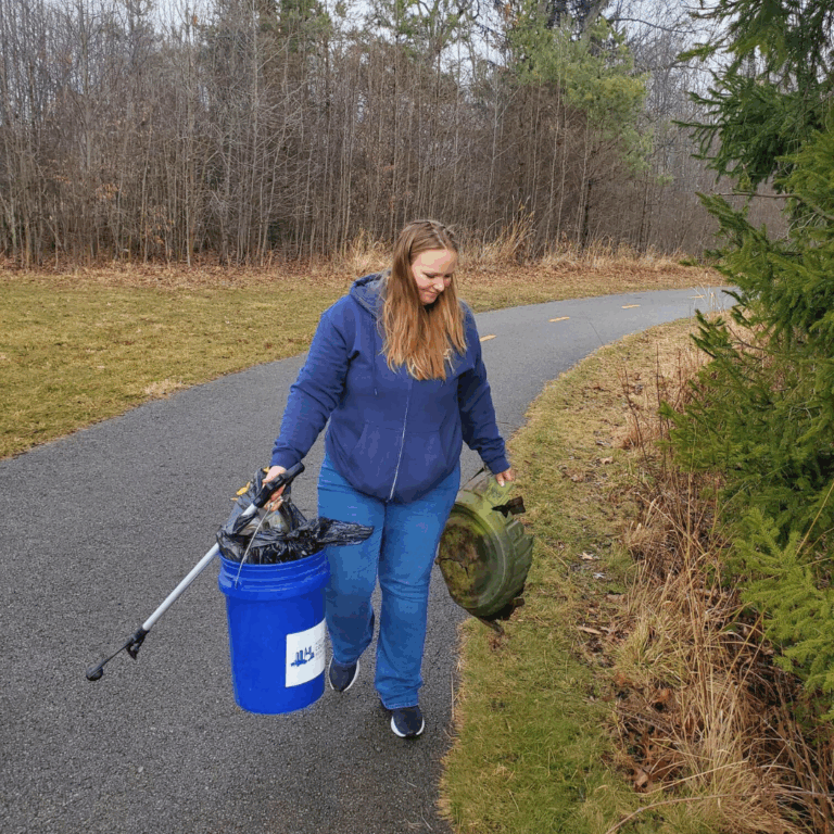 Custom Air employees give back during Service Day. This employee is shown picking up trash.