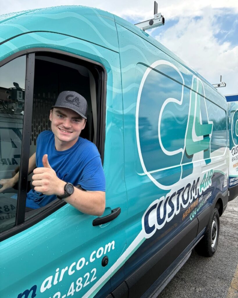 HVAC technician in a Custom Air company van in Columbus, Ohio