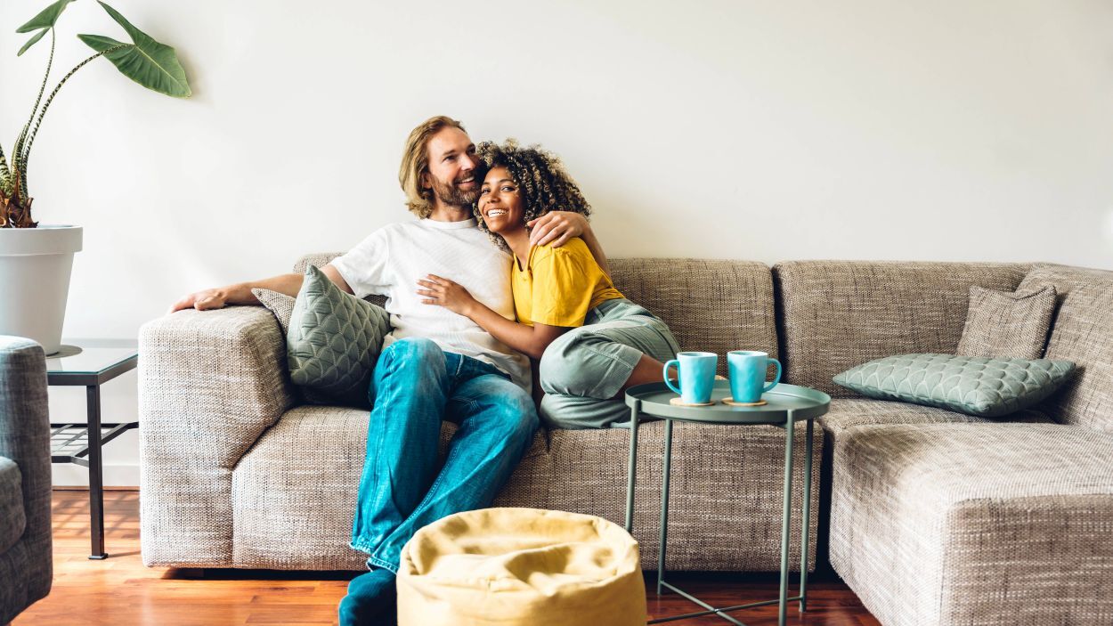 Happy couple sitting on sofa in the living room