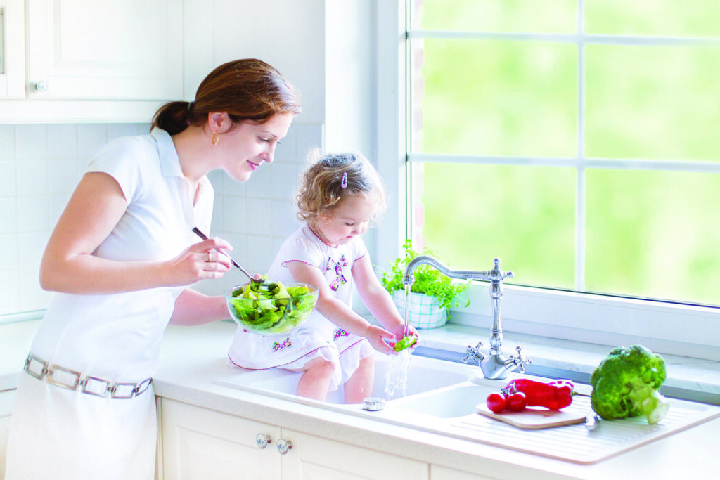 mother and daughter washing dishes